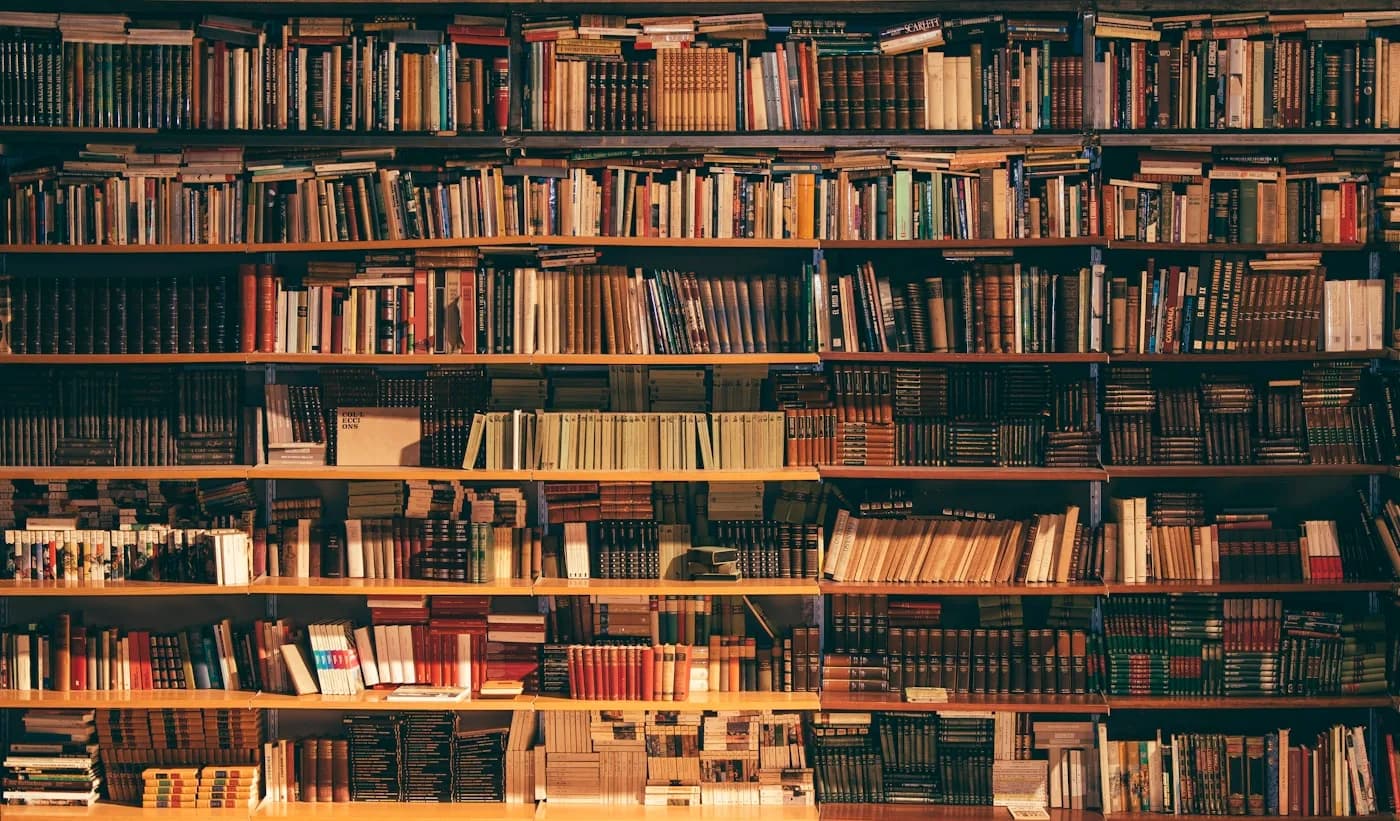 Library shelves of books — institutional knowledge your assistant should retrieve with citations